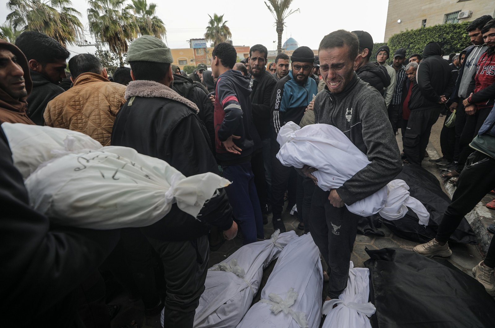 A father carries the body of his son following after being killed by an Israeli air strike on Deir al-Balah, Gaza Strip, Palestine, Feb. 23, 2024. (EPA Photo)