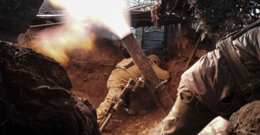 Ukrainian servicemen take cover as they shoot a mortar near Avdiivka, in the Donetsk area, Ukraine, Feb. 24, 2024. (EPA Photo)