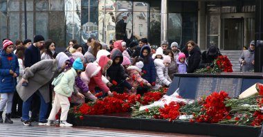 Children leave flowers at a monument dedicated to Khojaly Massacre victims, Baku, Azerbaijan, Feb. 26, 2024. (AA Photo)