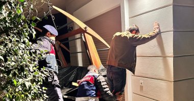 Gendarmerie officers search a suspect accused of financing the DHKP-C and MLKP terror groups during a raid in the western province of Izmir, Türkiye, Feb. 27, 2024. (AA Photo)