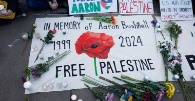 People leave notes and flowers during a vigil for U.S. Air Force active-duty airman Aaron Bushnell outside the Israeli Embassy, Washington, D.C., Feb. 26, 2024. (AFP Photo)