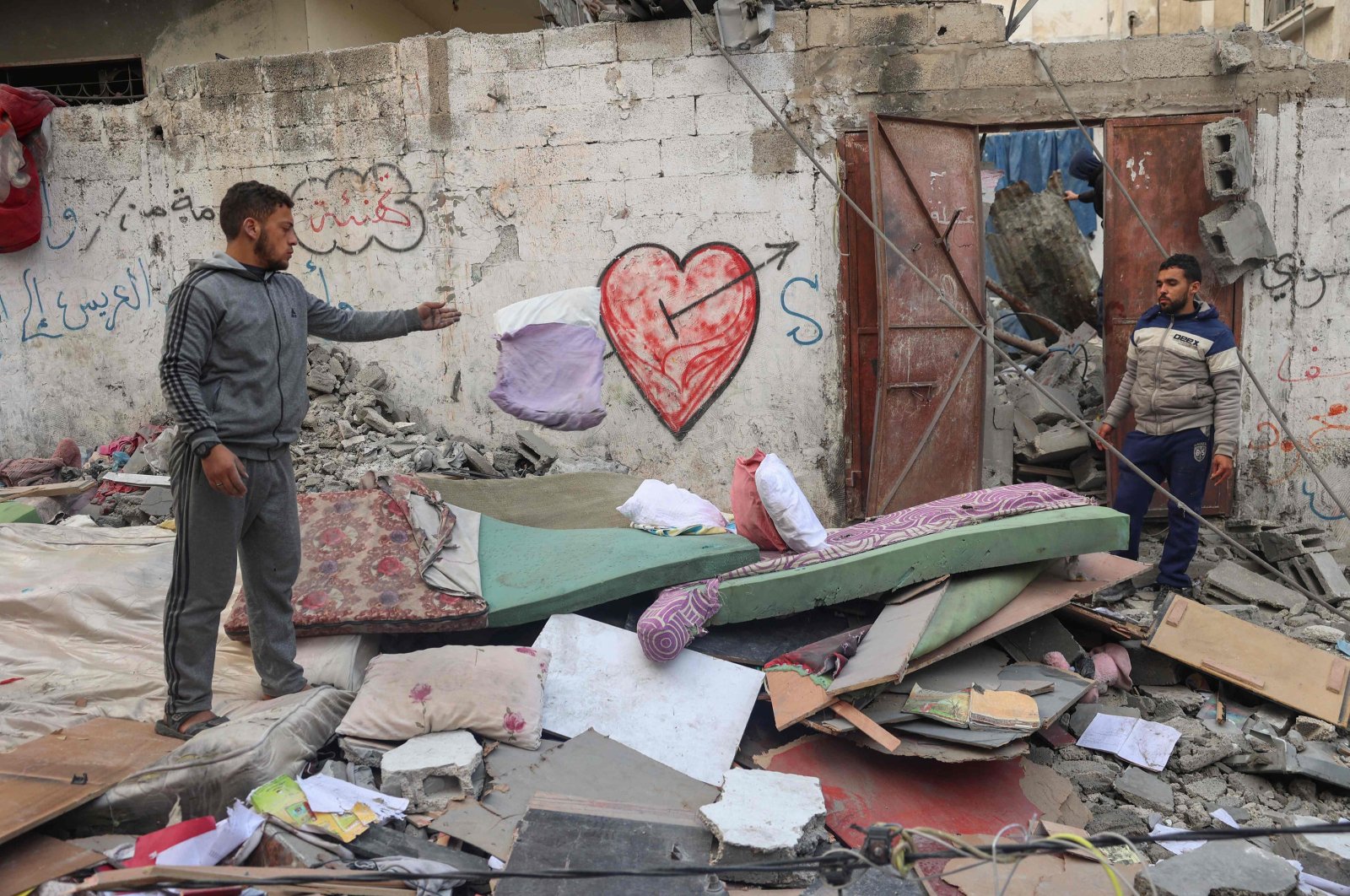 Palestinians salvage belongings from the rubble of buildings destroyed in an overnight Israeli airstrike in the Rafah refugee camp in southern Gaza Strip, Palestine, Feb. 27, 2024. (AFP Photo)