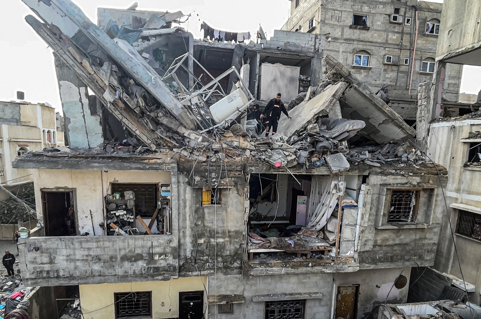 Palestinians search the rubble of their house destroyed in an overnight Israeli airstrike in Rafah, southern Gaza Strip, Palestine, Feb. 27, 2024. (AFP Photo)