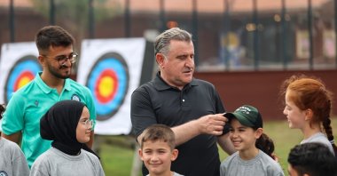 Youth and Sports Minister Osman Aşkın Bak (C) with children at the "First Step into Sport" project, Ankara, Türkiye, Feb. 28, 2024. (IHA Photo)