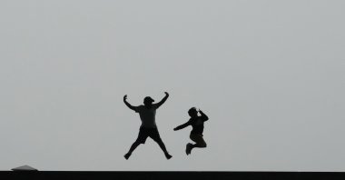 Children jump in the air to be taken pictures in Seoul, South Korea, Sept. 20, 2023. (AP Photo)