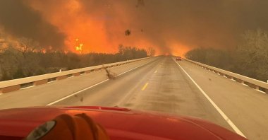 A fire truck drives toward the Smokehouse Creek Fire, near Amarillo, Texas, U.S., Panhandle, Feb. 27, 2024. (AFP Photo)