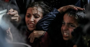 Palestinian children react to collect aid food in Beit Lahia, in the northern Gaza Strip, Palestine, Feb. 26, 2024. (AFP Photo)