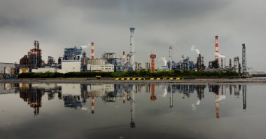 A petrochemical plant is reflected in a puddle at an industrial complex in Kawasaki near Tokyo, Japan, Aug. 31, 2015. (Reuters Photo)