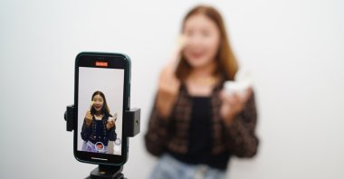 American girls aged 8 to 12 gain thousands of followers on TikTok by showcasing their makeup purchases. (Shutterstock Photo)