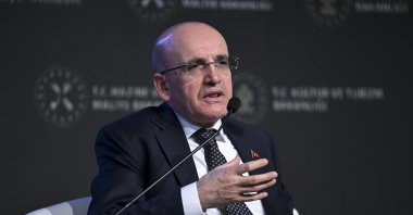 Treasury and Finance Minister Mehmet Şimşek delivers a speech during a business forum in Istanbul, Türkiye, Feb. 16, 2024. (AA Photo)