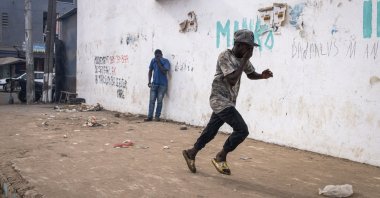 A protester runs from teargas during a march calling on authorities to respect the election date, in Dakar, Senegal, Feb. 16, 2024. (AFP Photo)