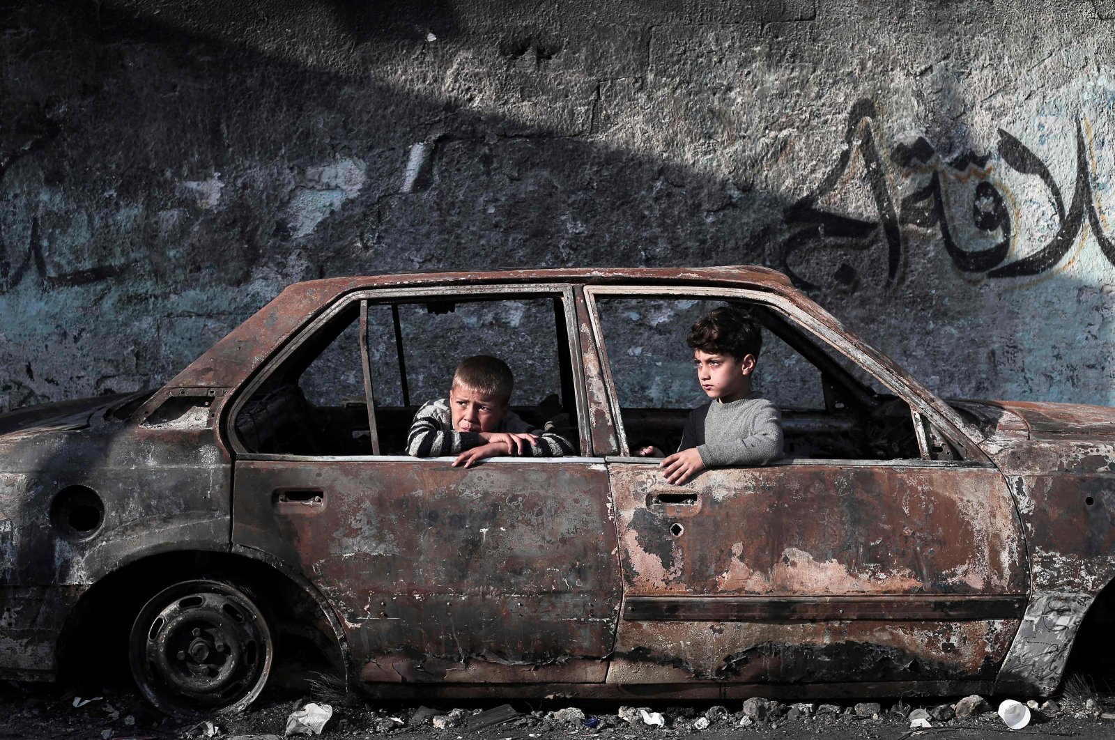Children sit in a destroyed car in Rafah, on the southern Gaza Strip, Palestine, Feb. 28, 2024. (AFP Photo)