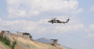 A Turkish Armed Forces (TSK) helicopter runs announcements for terrorists to surrender over mountains in Türkiye's Hakkari province bordering northern Iraq, Türkiye, Oct. 30, 2022. (DHA Photo)