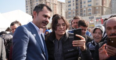 People take a selfie with Murat Kurum (L) in the Başakşehir district, Istanbul, Türkiye, Feb. 29, 2024. (İHA Photo)
