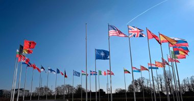 An empty mast amongst member nation flags in the Cour d&#039;Honneur of the NATO headquarters, ahead of a flag-raising ceremony for Sweden’s accession to NATO, in Brussels, Feb. 27, 2024. (AFP Photo)
