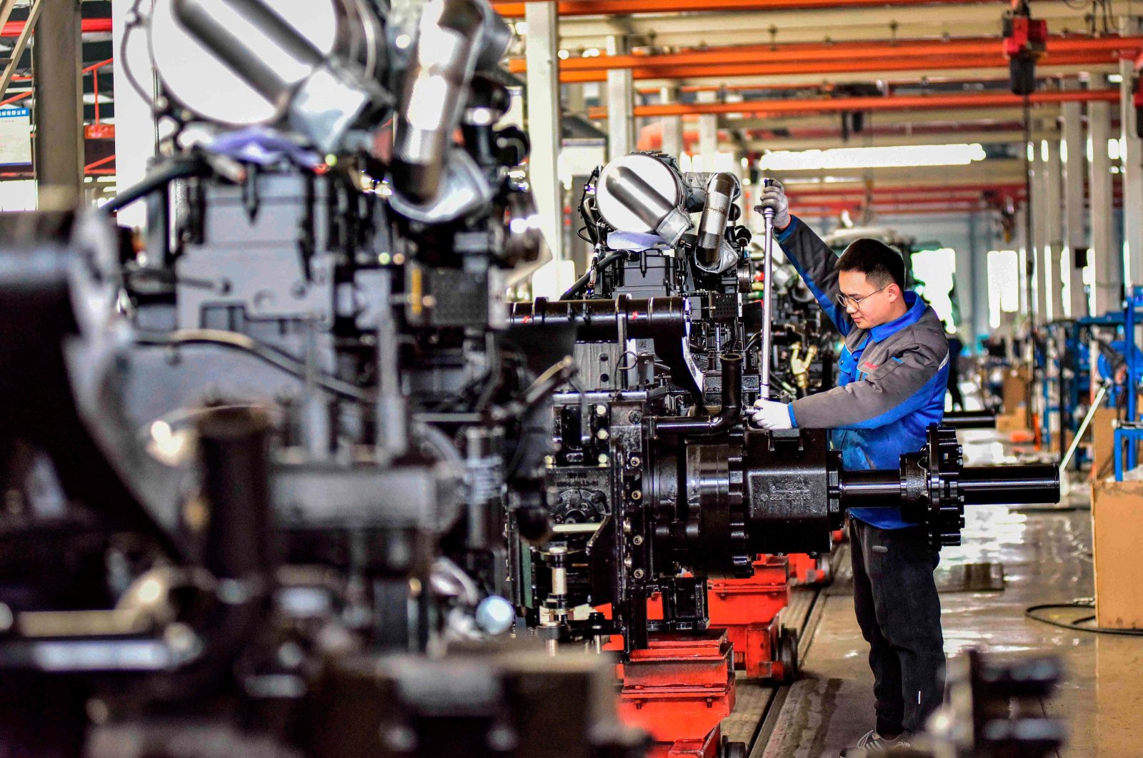 An employee works on a tractor production line at a factory in Weifang, eastern Shandong province, China, March 1, 2024. (AFP Photo)