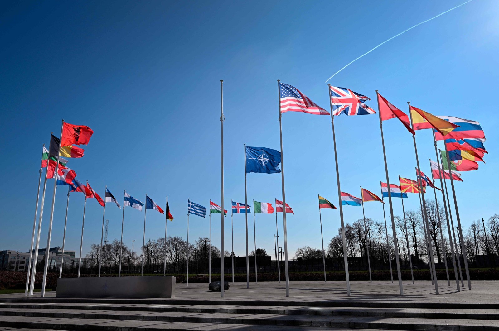 An empty mast amongst member nation flags in the Cour d&#039;Honneur of the NATO headquarters, ahead of a flag-raising ceremony for Sweden’s accession to NATO, in Brussels, Feb. 27, 2024. (AFP Photo)