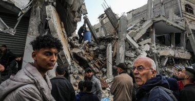 Palestinians gather to inspect a building damaged by Israeli airstrikes in Rafah, Gaza, Palestine, March 4, 2024. (AA Photo)