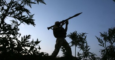 A Ukrainian serviceman attends on his position along the front line with Russia-backed separatists near the small town of Krasnogorivka, in the Donetsk region on July 20, 2021. (AFP File Photo)