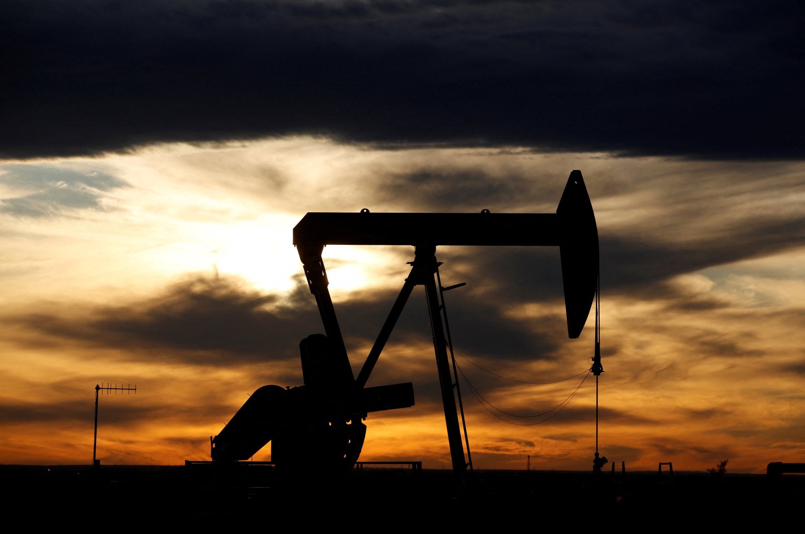 The sun sets behind a crude oil pump jack on a drill pad in the Permian Basin, Loving County, Texas, U.S., Nov. 24, 2019. (Reuters Photo)