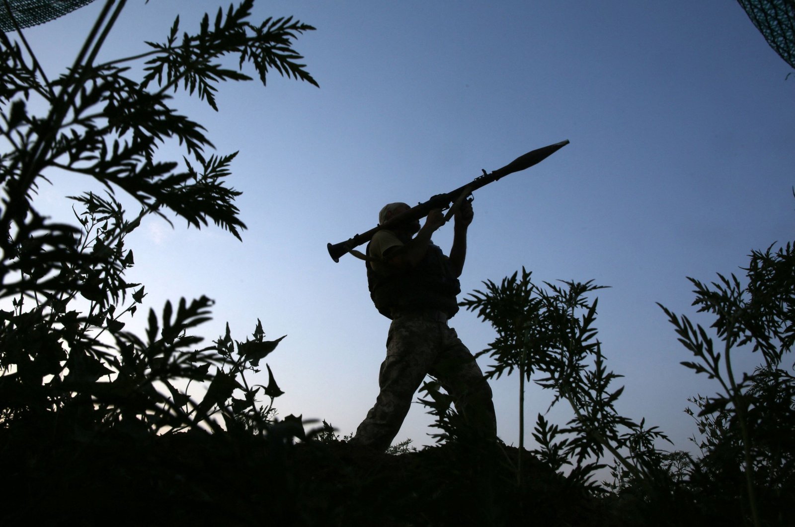 A Ukrainian serviceman attends on his position along the front line with Russia-backed separatists near the small town of Krasnogorivka, in the Donetsk region on July 20, 2021. (AFP File Photo)