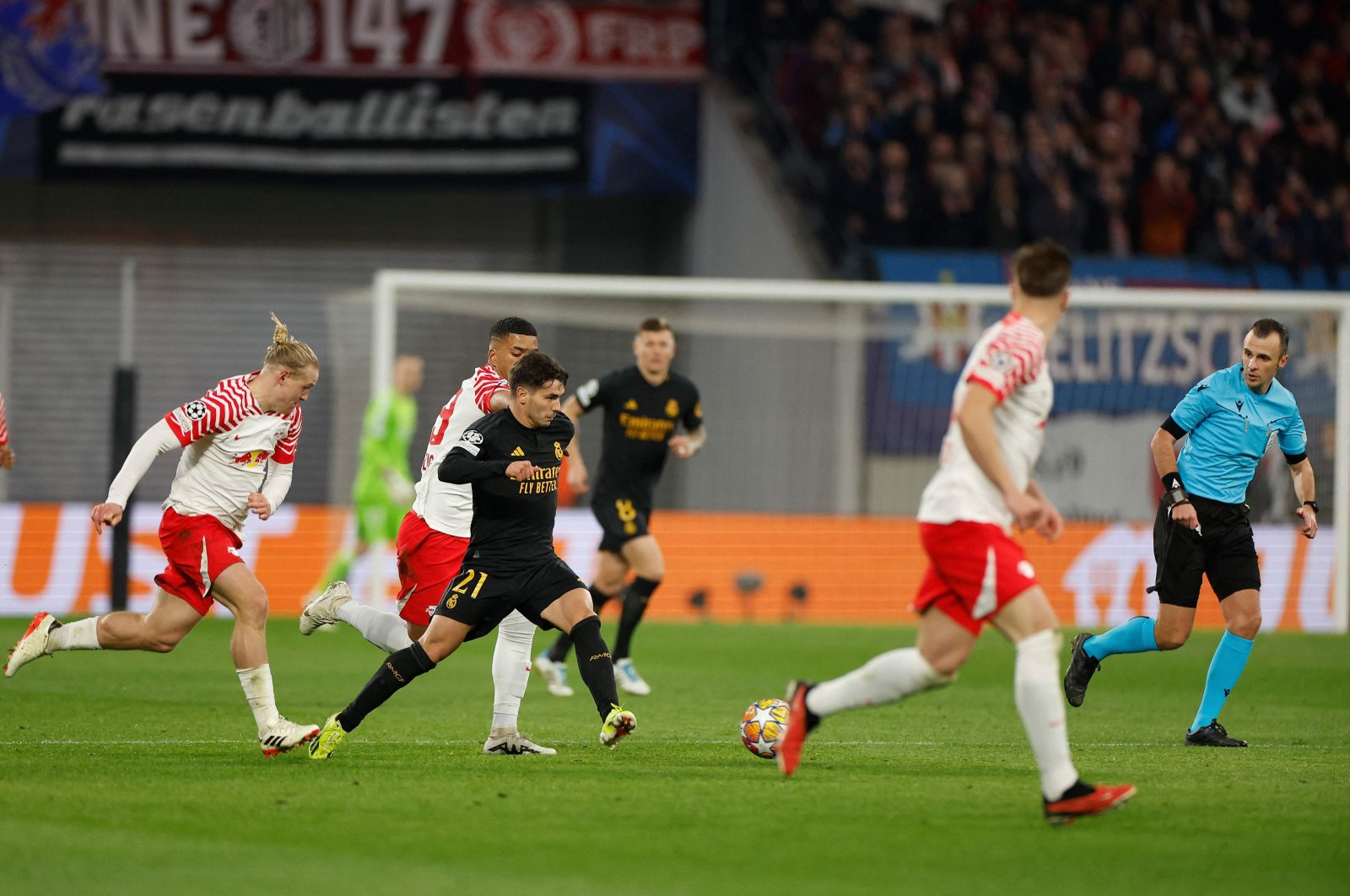 Real Madrid&#039;s Brahim Diaz (C) gets away from Leipzig&#039;s Xaver Schlager (L) and Leipzig&#039;s Benjamin Henrichs during the UEFA Champions League Round of 16, first-leg football match, Leipzig, Germany, Feb. 13, 2024. (AFP Photo)