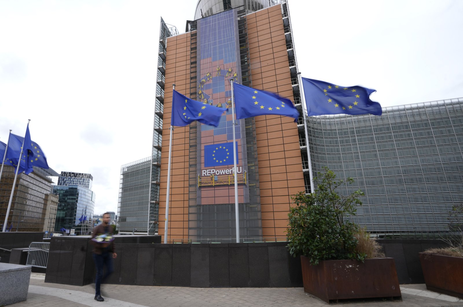 Flags flap in the wind in front of EU headquarters in Brussels, Sept. 20, 2023. (AP Photo)