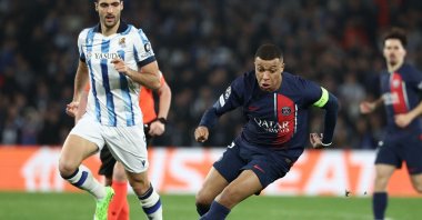 Paris Saint-Germain&#039;s Kylian Mbappe (R) is challenged by Real Sociedad&#039;s Mikel Merino during the UEFA Champions League last 16 second leg match at the Anoeta stadium, San Sebastian, Spain, March 5, 2024. (AFP Photo)