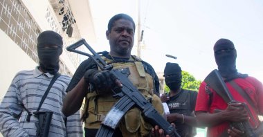 Armed gang leader Jimmy "Barbecue" Cherisier (C) and his men are seen in Port-au-Prince, Haiti, March 5, 2024. (AFP Photo)