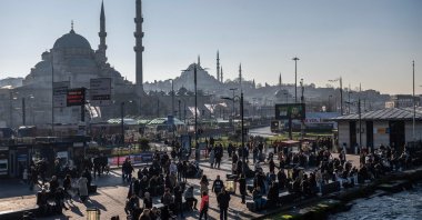 Pedestrians walk next to a ferryboat port in the Eminönü district, Istanbul, Türkiye, Feb. 22, 2024. (AFP Photo)