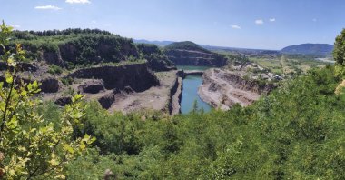  Gostry Verkh area of the Korolevo I archaeological site in western Ukraine in August 2023, with the Korolevo II site behind a body of water. (AP Photo)