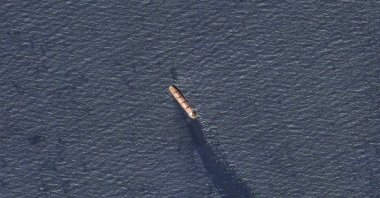 In this satellite image provided by Planet Labs, the Belize-flagged bulk carrier Rubymar is seen in the southern Red Sea near the Bay el-Mandeb Strait leaking oil after an attack by Yemen's Houthi rebels Tuesday, Feb. 20, 2024. (AP Photo)