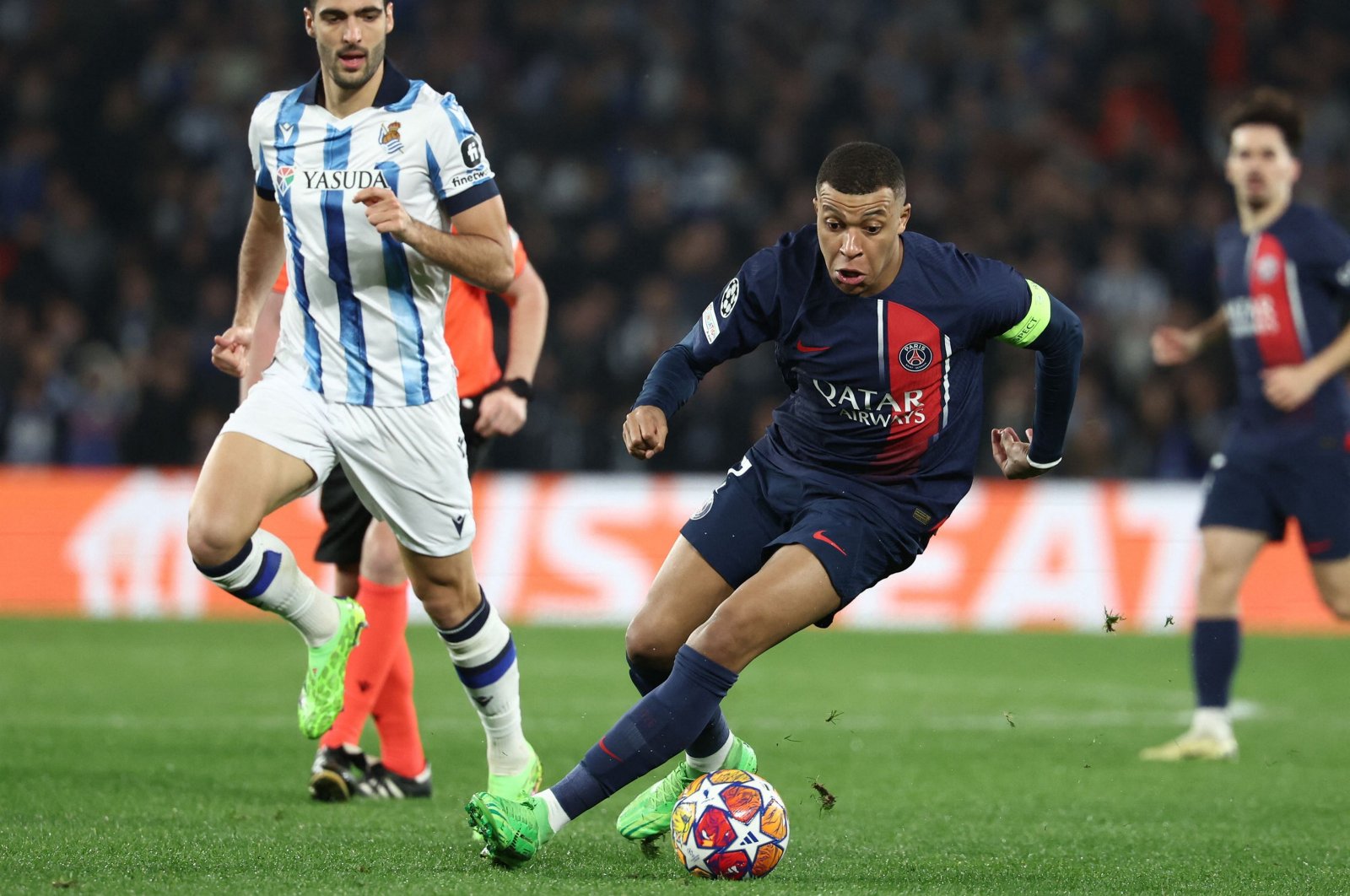 Paris Saint-Germain&#039;s Kylian Mbappe (R) is challenged by Real Sociedad&#039;s Mikel Merino during the UEFA Champions League last 16 second leg match at the Anoeta stadium, San Sebastian, Spain, March 5, 2024. (AFP Photo)