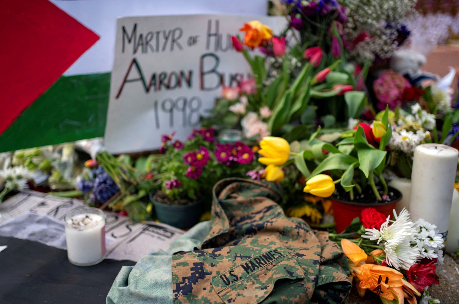 A United States Marines jacket, flowers and candles are placed outside the Israeli Embassy in Washington at a memorial for Aaron Bushnell, an active duty U.S. Air Force member who died after setting himself on fire outside the embassy in an act of protest against the war in Gaza, Washington, U.S., March 2, 2024. (Reuters Photo)