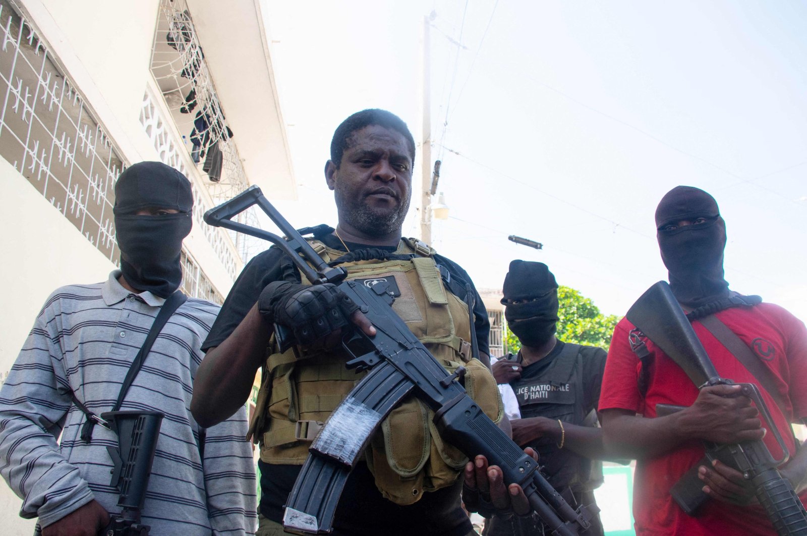 Armed gang leader Jimmy "Barbecue" Cherisier (C) and his men are seen in Port-au-Prince, Haiti, March 5, 2024. (AFP Photo)