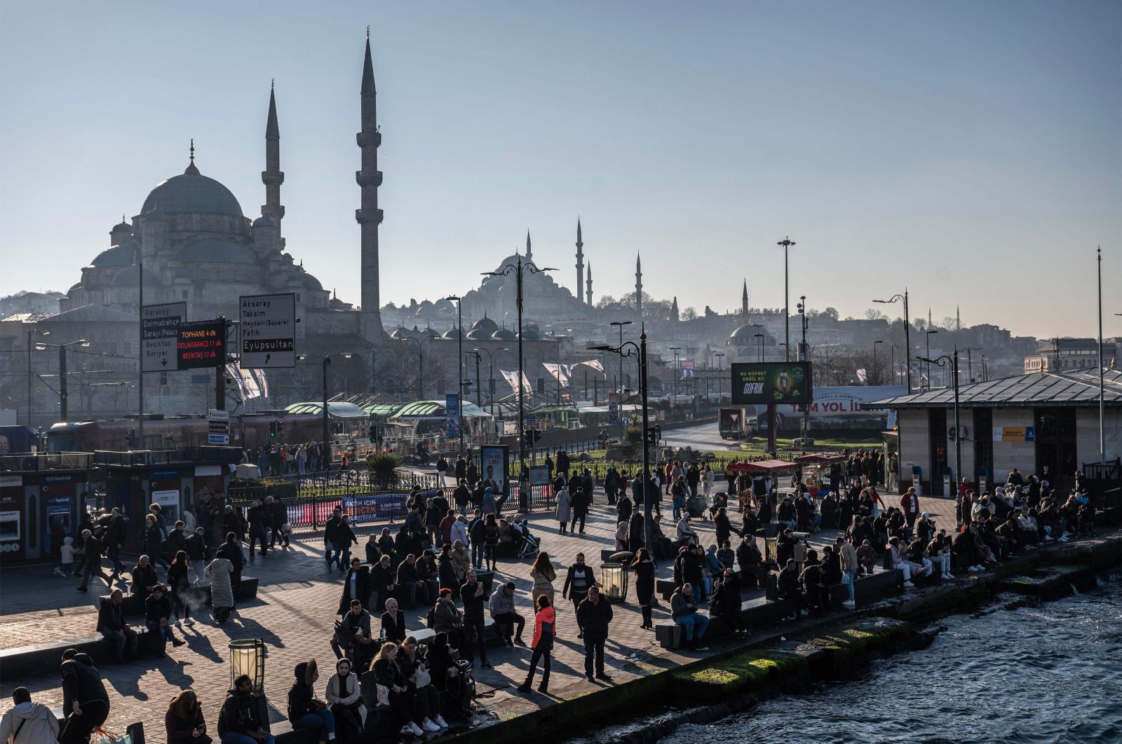 Pedestrians walk next to a ferryboat port in the Eminönü district, Istanbul, Türkiye, Feb. 22, 2024. (AFP Photo)