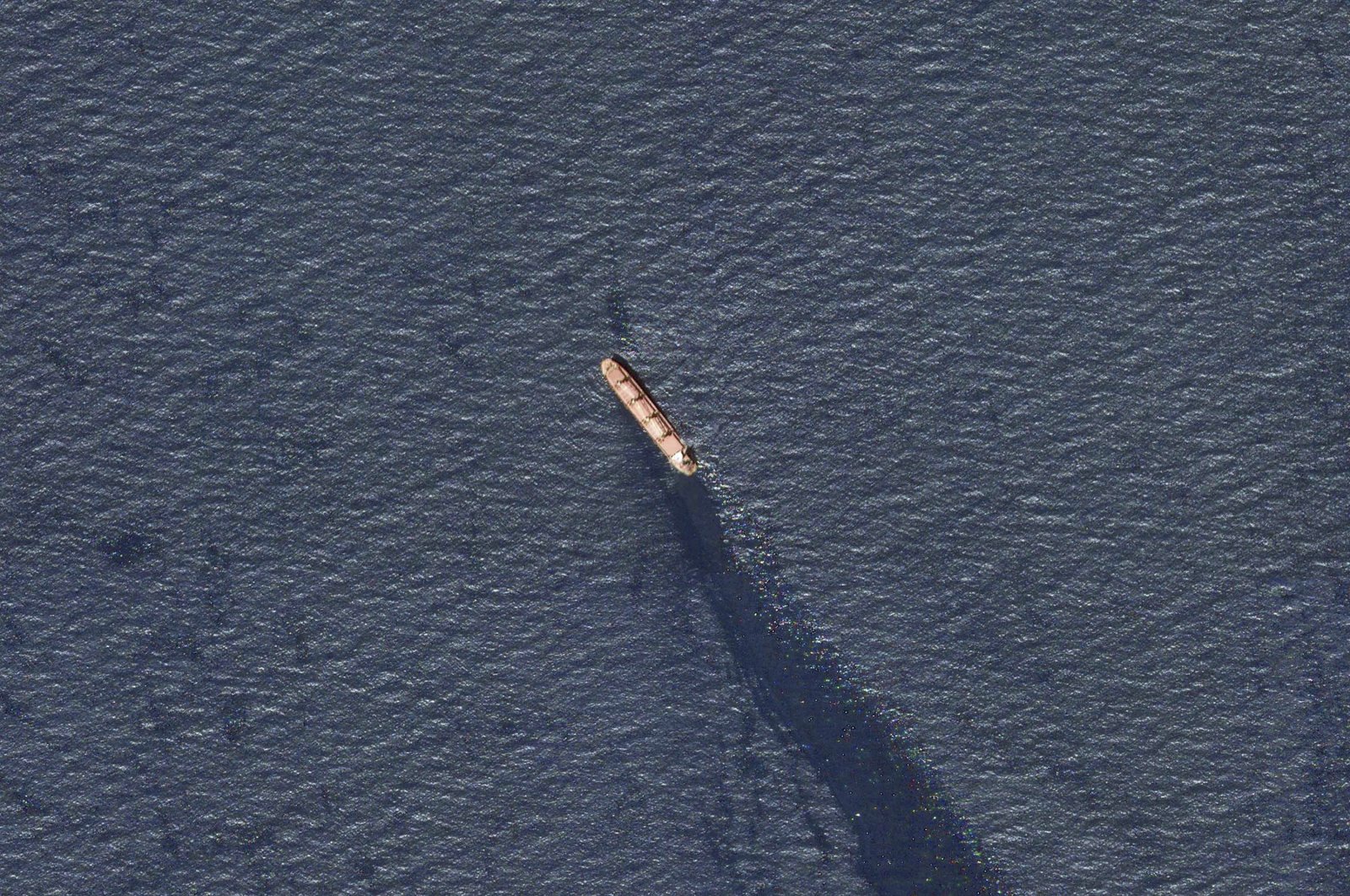 In this satellite image provided by Planet Labs, the Belize-flagged bulk carrier Rubymar is seen in the southern Red Sea near the Bay el-Mandeb Strait leaking oil after an attack by Yemen&#039;s Houthi rebels Tuesday, Feb. 20, 2024. (AP Photo)