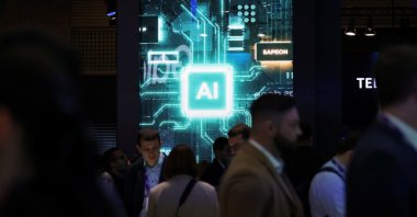 People walk near a sign for Sapeon, an artificial intelligence (AI) chip company, at the Mobile World Congress (MWC) in Barcelona, Spain, Feb. 27, 2024. (Reuters Photo)