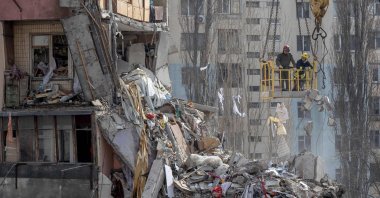 Rescuers clear debris from a multi-story building heavily damaged following a drone strike, in Odesa, Ukraine, March 3, 2024. (AFP Photo)