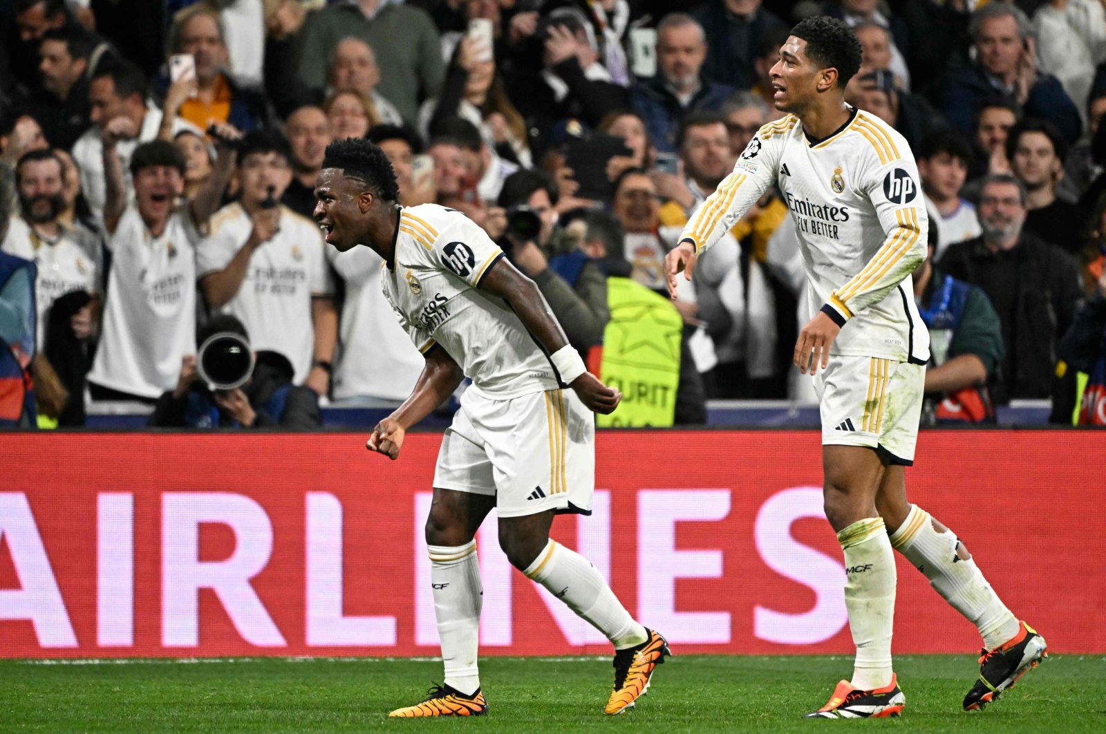 Real Madrid&#039;s Vinicius Junior (L) celebrates scoring the opening goal, with Jude Bellingham, during the UEFA Champions League last 16 second leg football match against RB Leipzig at the Santiago Bernabeu stadium, Madrid, Spain, March 6, 2024. (AFP Photo)