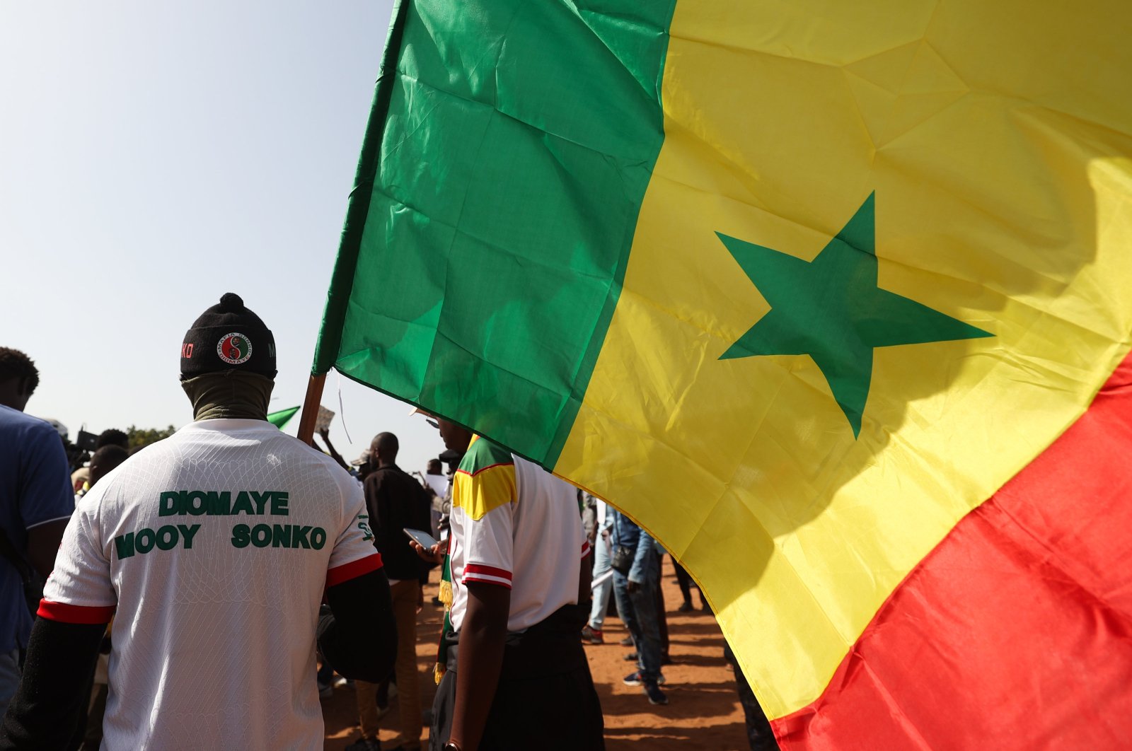 A demonstrator raises Senegal&#039;s national flag during a march in Dakar, Senegal, March 2, 2024. (AFP Photo)
