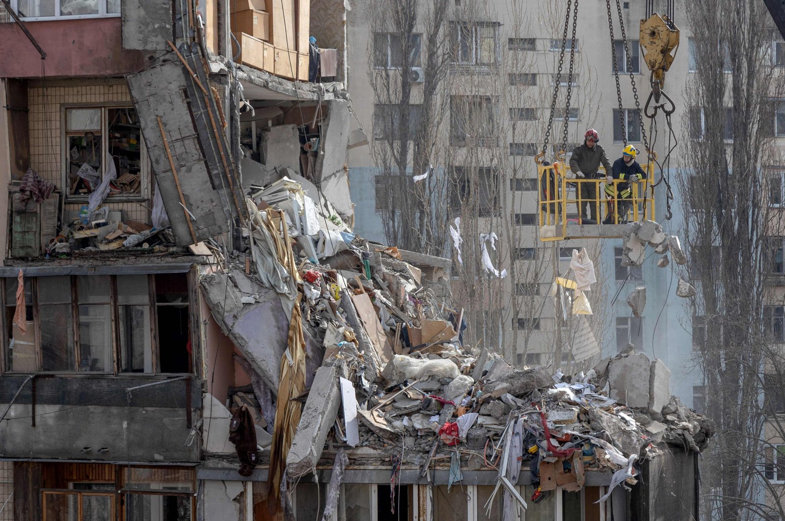 Rescuers clear debris from a multi-story building heavily damaged following a drone strike, in Odesa, Ukraine, March 3, 2024. (AFP Photo)