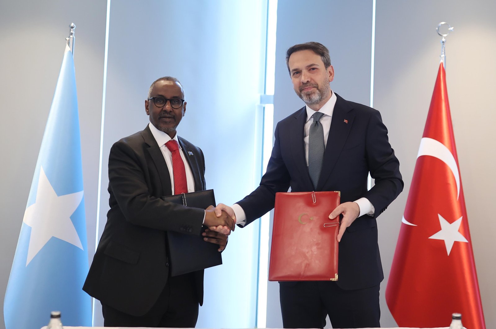 Energy Minister Alparslan Bayraktar shakes hands with Somalia&#039;s Petroleum and Mineral Resources Minister Abdirizak Omar Mohamed, Ankara, Türkiye, March 7, 2024. (DHA Photo)
