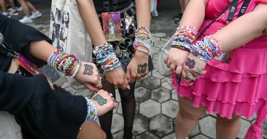Fans of U.S. singer Taylor Swift, also known as "Swifties," display friendship bracelets as they arrive for the first of the pop star's six sold-out Eras Tour concerts at the National Stadium in Singapore, March 2, 2024. (AFP Photo)