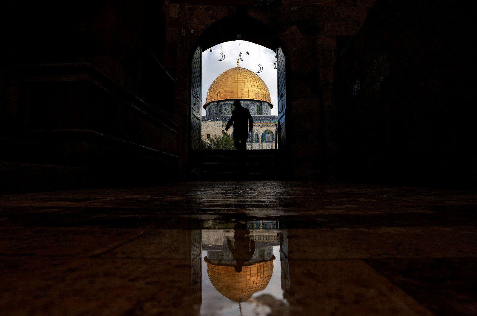 A man walks by the entrance to the Al-Aqsa Mosque, also known to Jews as the Temple Mount, amid the ongoing Israel-Palestine conflict, the Old City, occupied East Jerusalem, Palestine, March 7, 2024. (Reuters Photo)