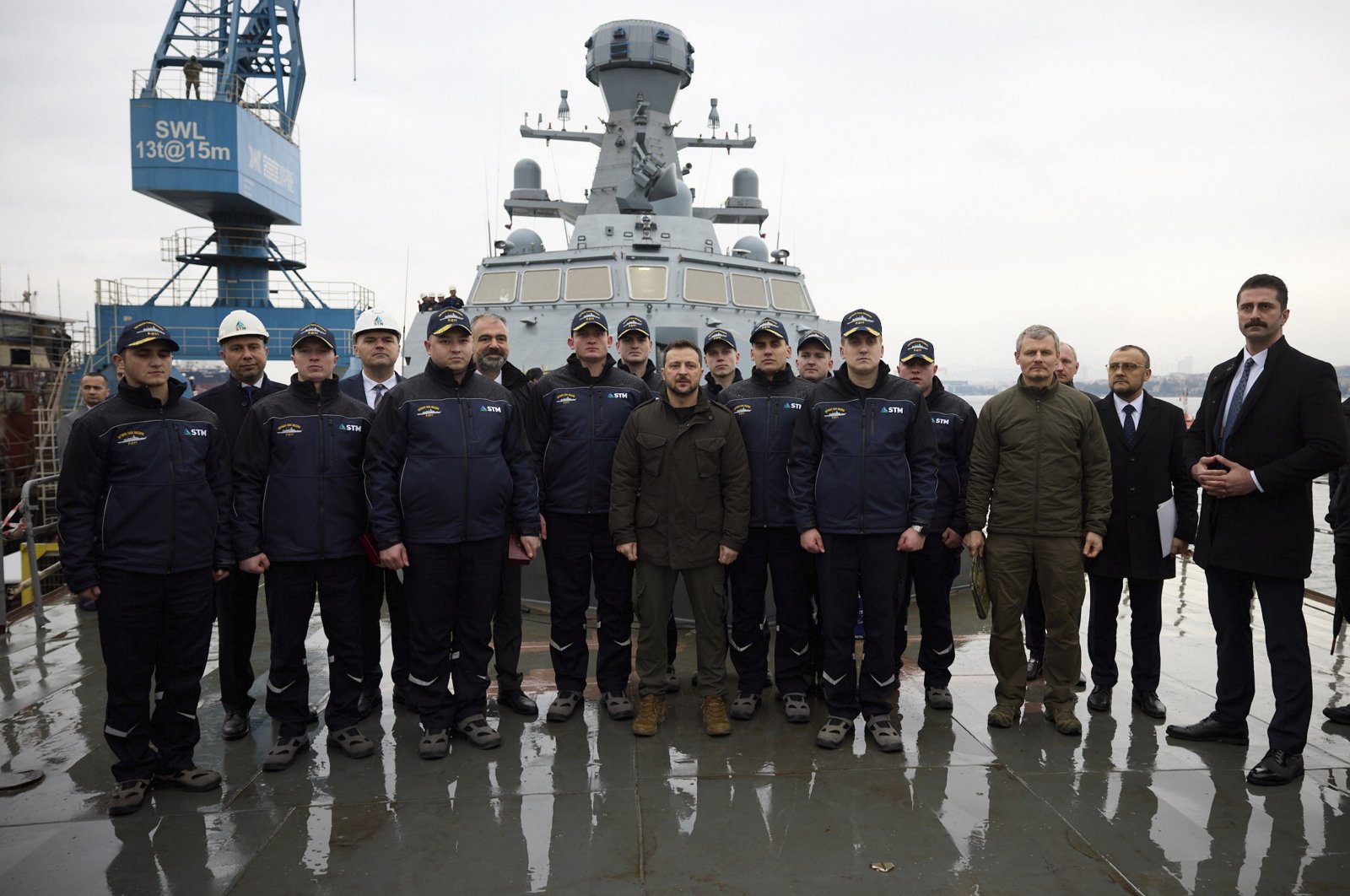 Ukrainian President Volodymyr Zelenskyy visits a shipyard in Istanbul, where he poses with Ukrainian Navy personnel undergoing training on the operation and maintenance of the Ivan Mazepa Corvette being built for the Ukrainian Naval Force, Istanbul, March 8, 2024. (Ukrainian Presidential Press Service Handout via AFP)