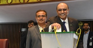 This handout photograph taken and released by the Pakistan National Assembly on March 9, 2024 shows presidential candidate and the leader of Pakistan Peoples Party (PPP) Asif Ali Zardari (2R) casting his ballot to vote during the presidential election at the Parliament House in Islamabad. (Pakistan National Assembly via AFP)