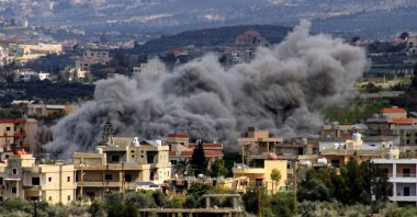 Smoke billows above buildings following an Israeli strike in the southern Lebanese border village of Majdal Zoun, March 9, 2024. (AFP Photo)