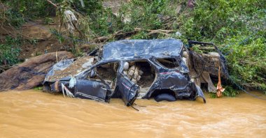 The wreckage of a car swept away by flash flooding is seen by a river bank in Pesisir Selatan Regency, West Sumatra, Indonesia, March 9, 2024. (AFP Photo)