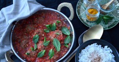 Mint leaves and chunky tomato sauce add a fresh touch to these bulgur meatballs. (dpa Photo)